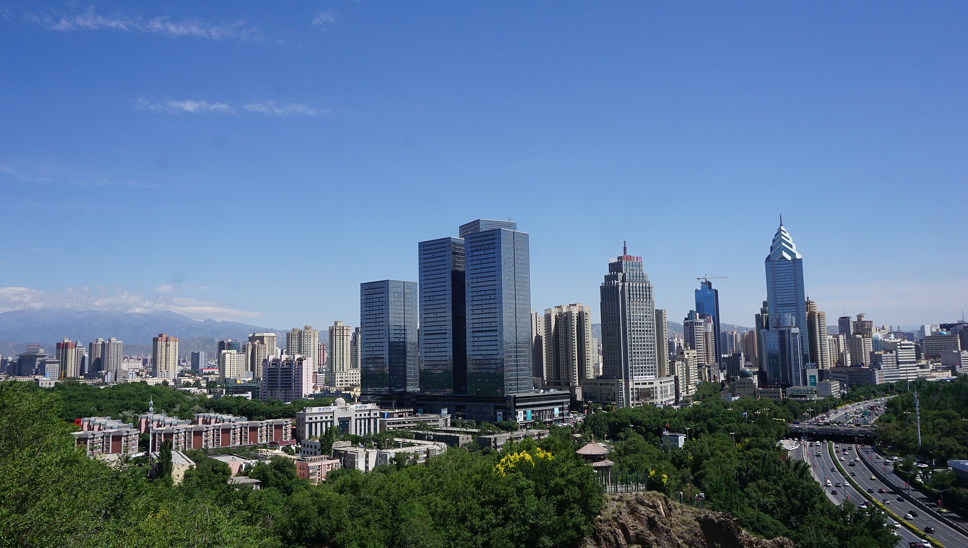 Urumqi skyline with the city stretching below mountain light.